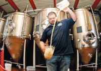 suds_sand The new mystery beer night at T.J. Finley's in Bay Shore is attracting a "new breed of local beer enthusiasts." Above Black Forest Brew Haus brewmaster Joe Hayes works up some froth to sate that enthusiasm.