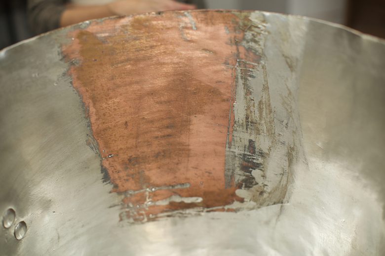 East Greenwich, RI - March 9, 2016: In the studio of East Coast Tinning, where owner, Jim Hamann restores antique copper pots and creates new ones. CREDIT: Clay Williams for Edible Manhattan. © Clay Williams / claywilliamsphoto.com