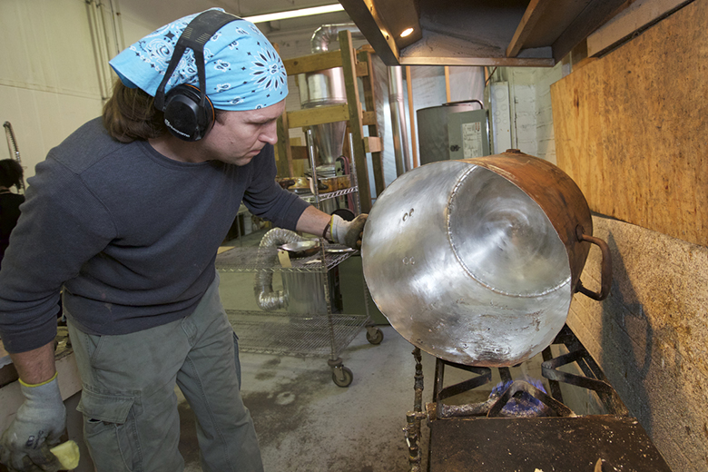 East Greenwich, RI - March 9, 2016: In the studio of East Coast Tinning, where owner, Jim Hamann restores antique copper pots and creates new ones. CREDIT: Clay Williams for Edible Manhattan. © Clay Williams / claywilliamsphoto.com