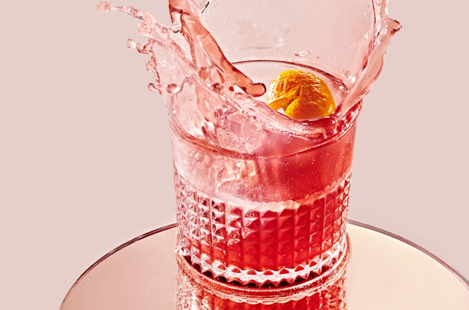 pink-red sorel cocktail splashing out of glass