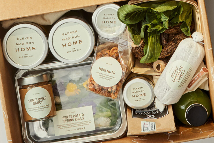 eleven madison home box filled with plant-based meals, fresh produce and lots of goodies in jars