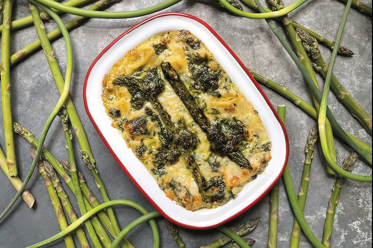 mac n cheese with ramp pesto surrounded by cooked asparagus