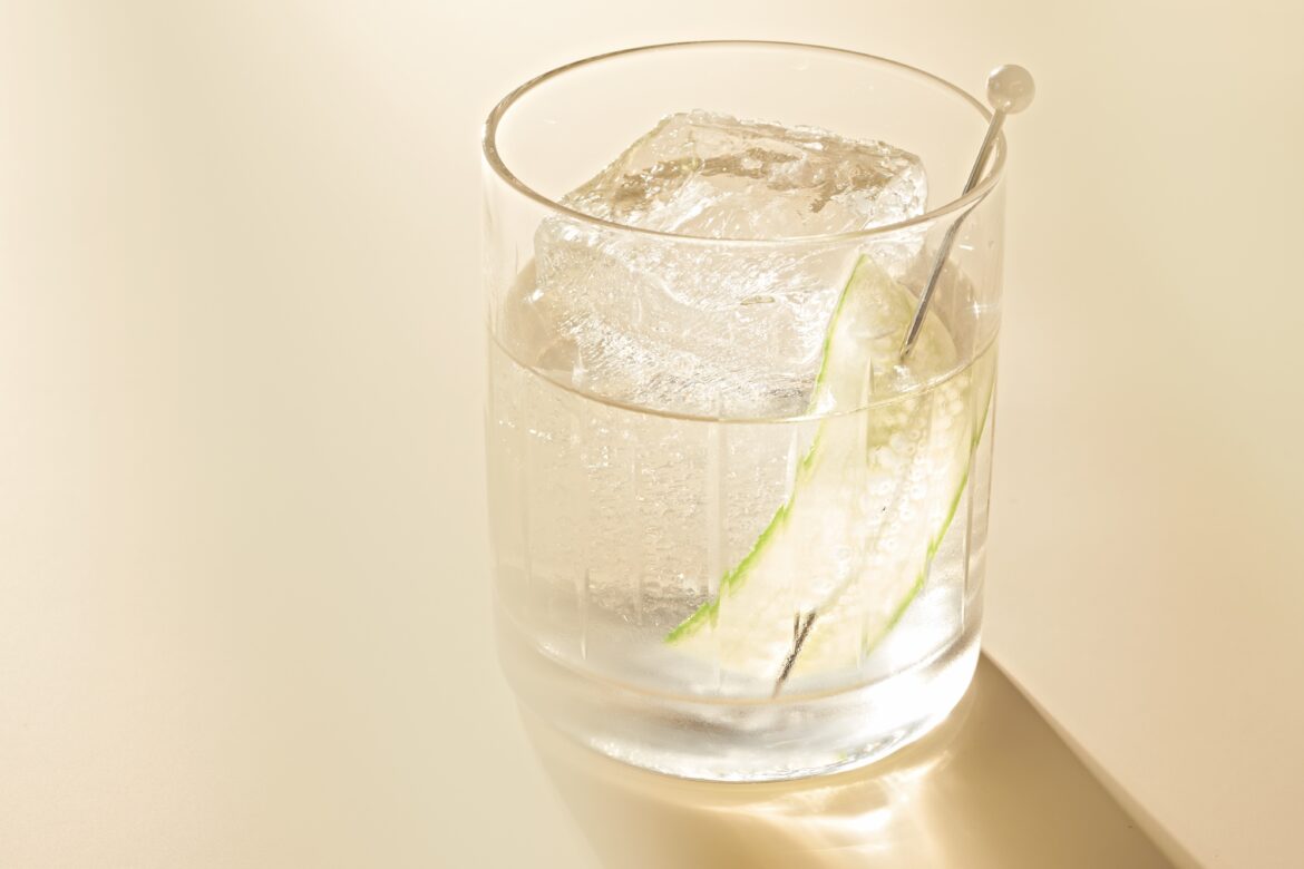 a white negroni cocktail with light shining through it