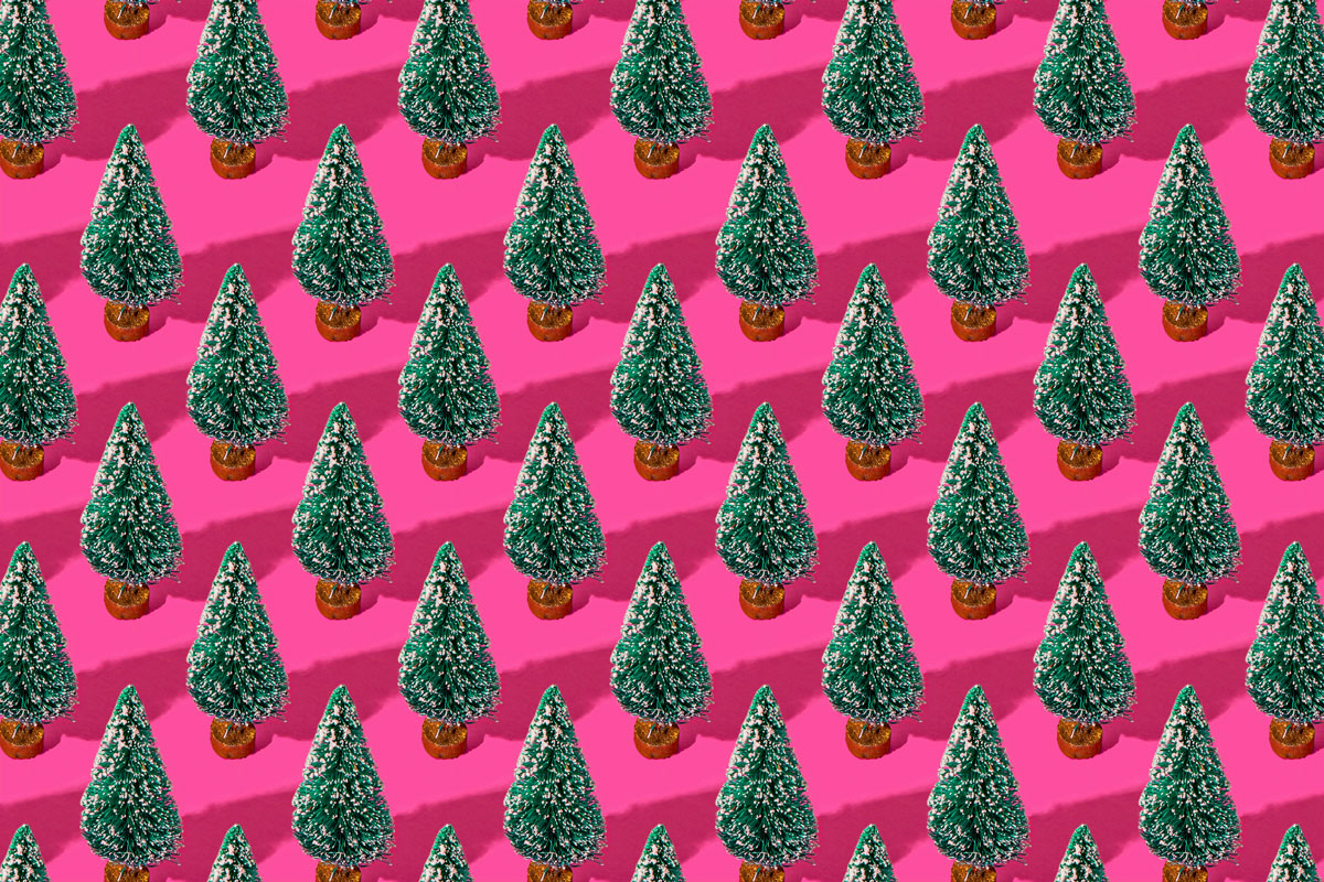 fake christmas trees repeated on a pink background