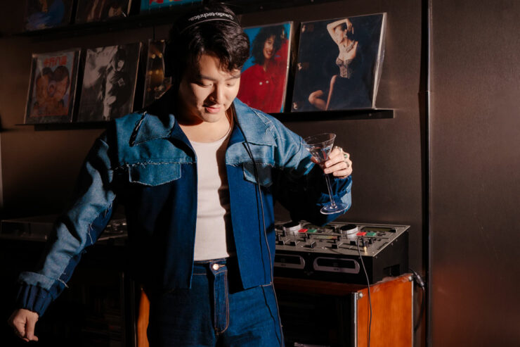 drinks influencer jae bae listens to music while holding a cocktail